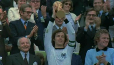 Franz Beckenbauer holding trophy